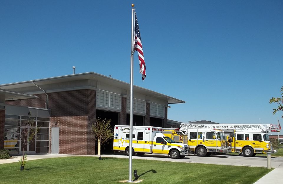 The Clinton Fire Department building with a yellow ambulance, and 2 yellow fire trucks.
