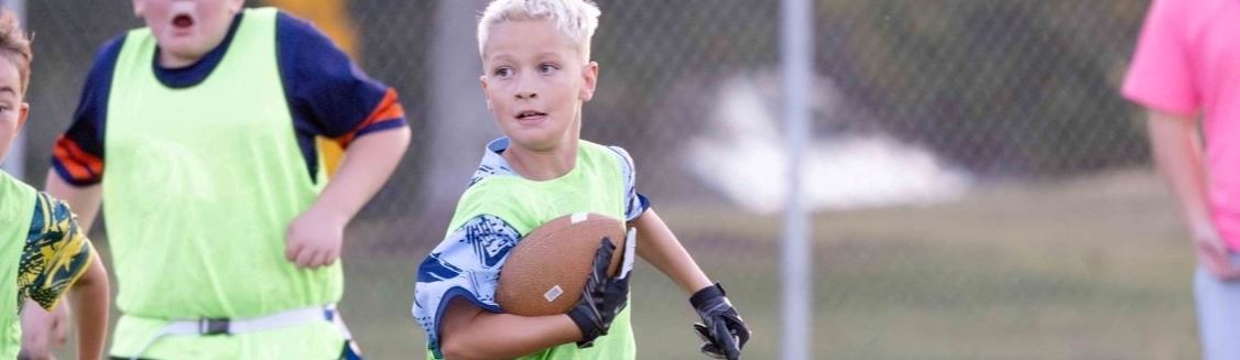 A boy running with a football