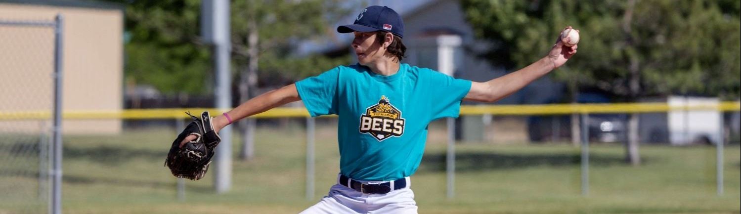 A baseball player pitching the ball