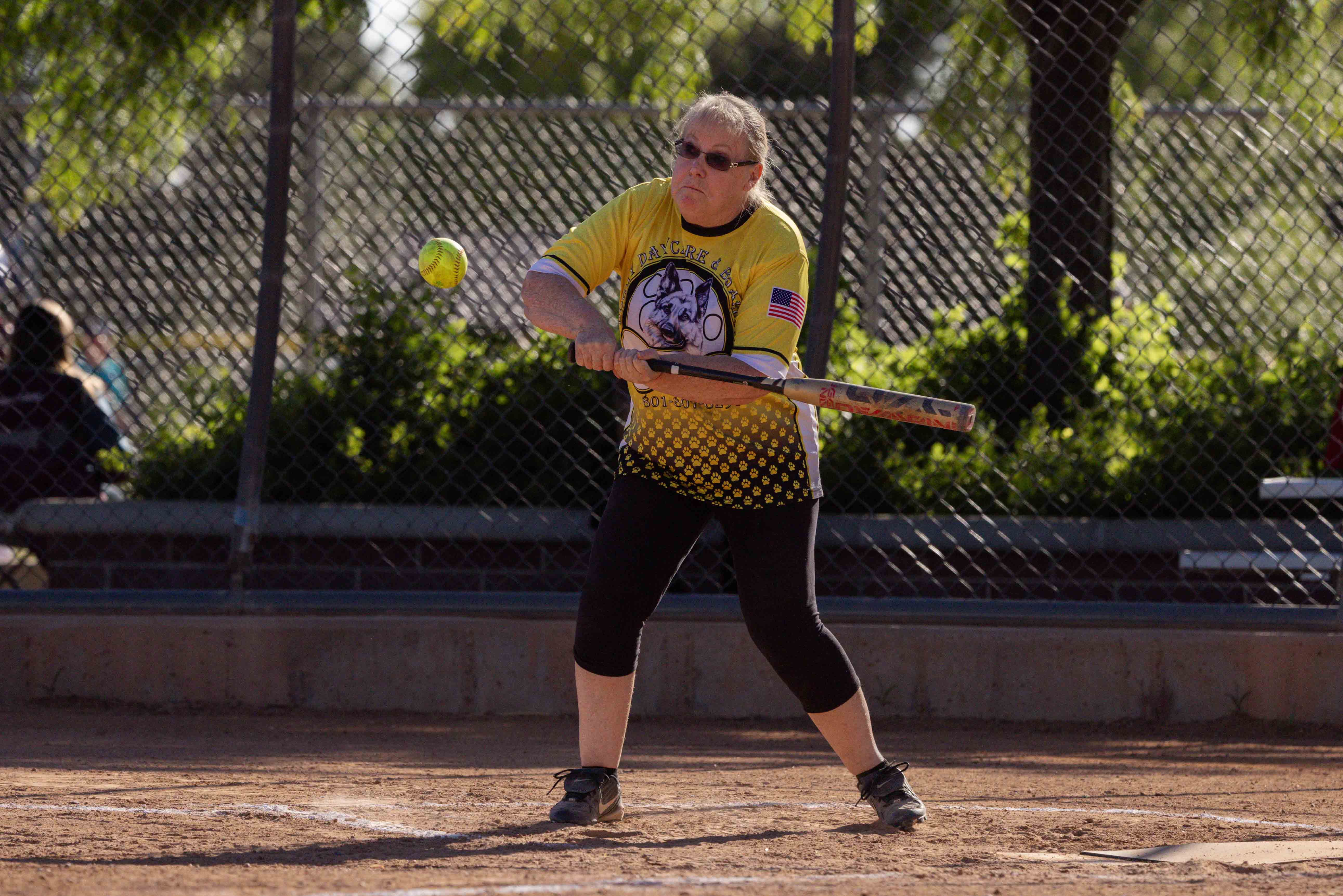A softball player batting the ball