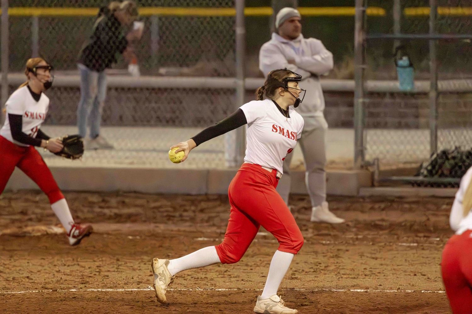 A softball player pitching