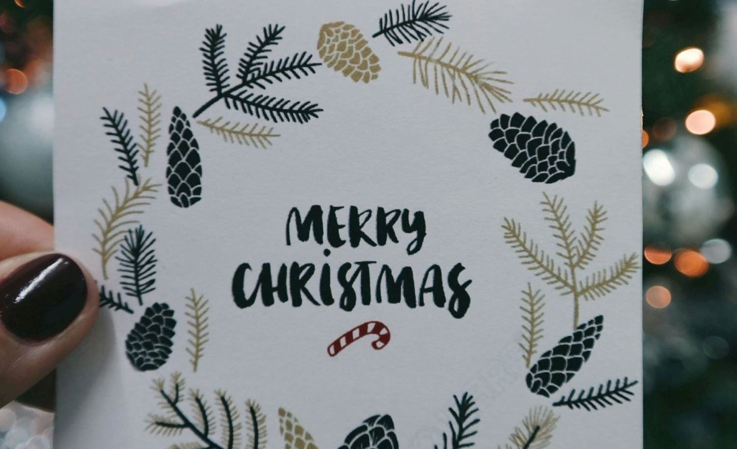 A person holding a Christmas card