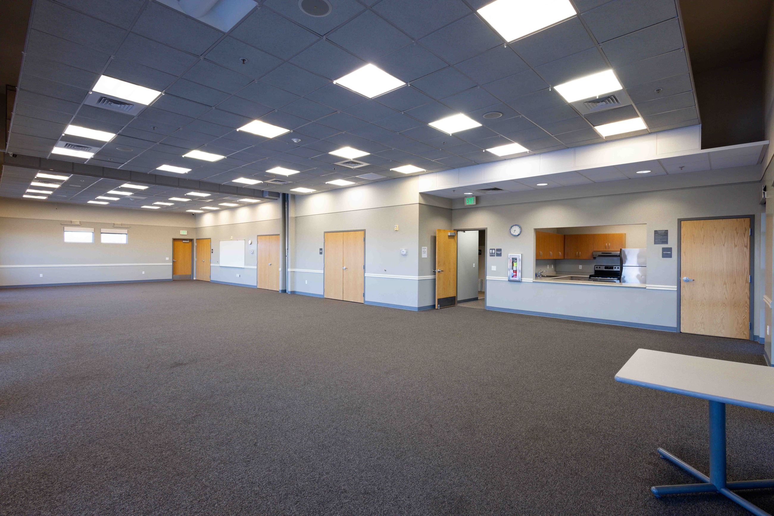 an empty room with an indoor kitchen